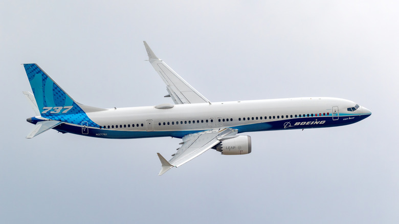 A Boeing 737 Max 10 in a demonstration flight against a cloudy sky