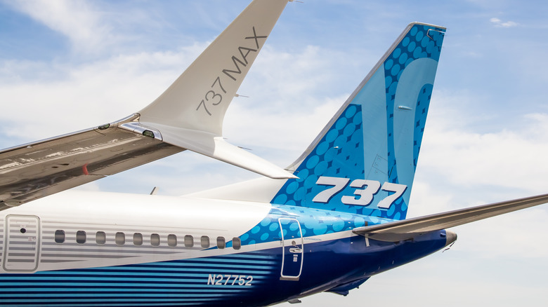 The rear of a 737 Max 10 against a partly cloudy sky