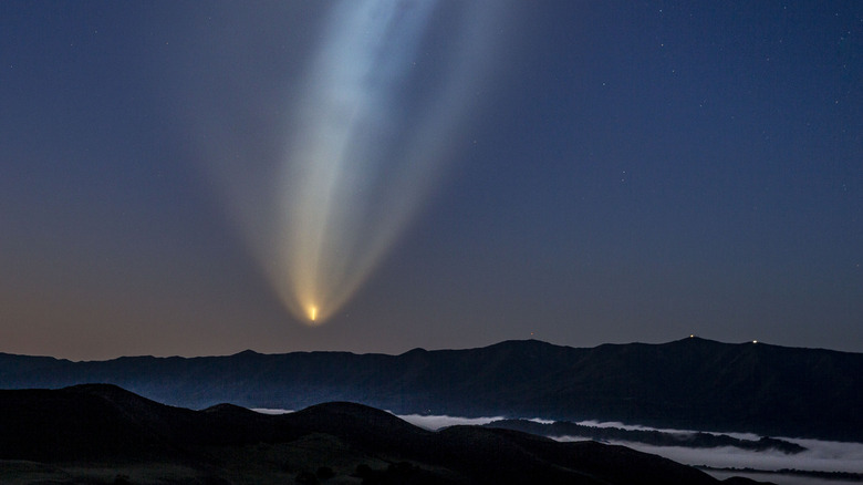 The exhaust trail of a SpaceX Falcon 9 against an evening sky