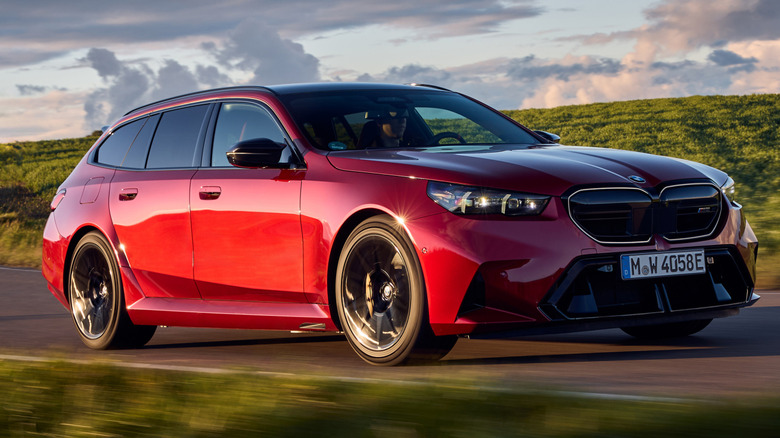 A red 2026 BMW M5 Touring while cornering