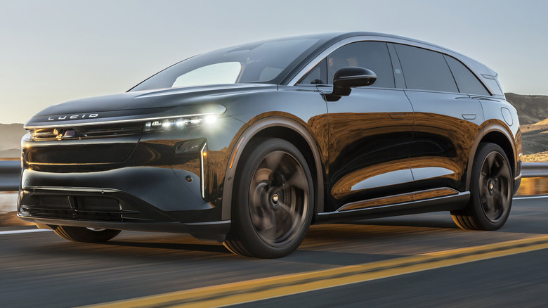 A black 2026 Lucid Gravity Dream Edition on a highway with mountains behind it.