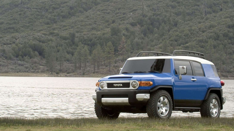 a honda element parked by a lake
