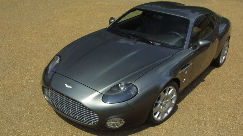 An Aston Martin V12 Vantage parked on gold-colored cement