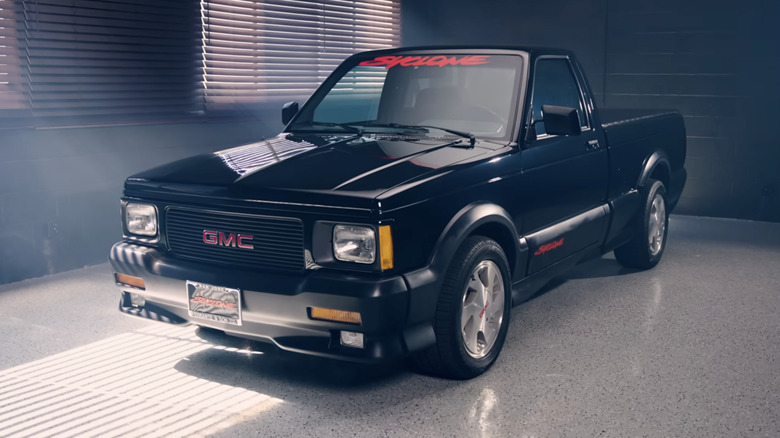 A black 1991 GMC Syclone parked in a room with sun streaming through the blinds