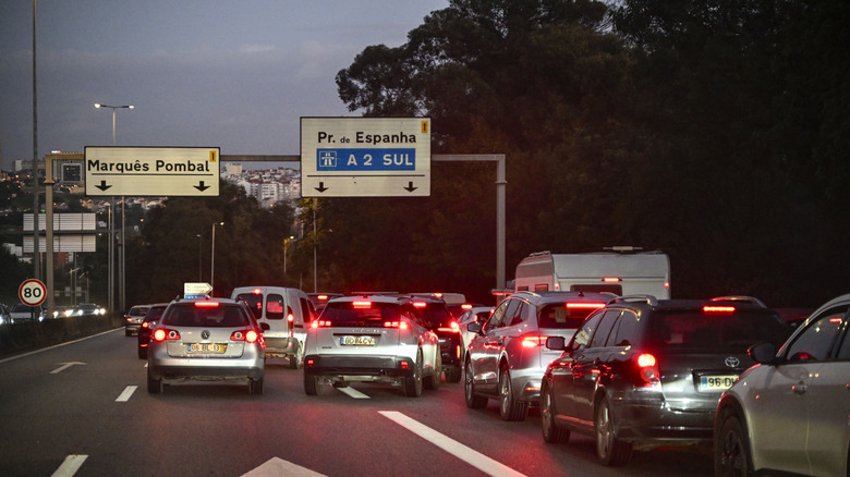 Vehicles drive bumper to bumper while forking towards Lisbon and across 25 de Abril bridge in A5 highway during a rainy afternoon rush hour on November 07, 2025 in Lisbon, Portugal.