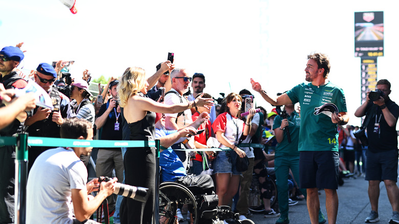 Fernando Alonso greets the crowd at the 2026 Spanish GP.