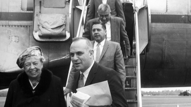 Eleanor Roosevelt, former first lady of the United States and widow of President Franklin D. Roosevelt, with several men leaving Air Force One in 1960