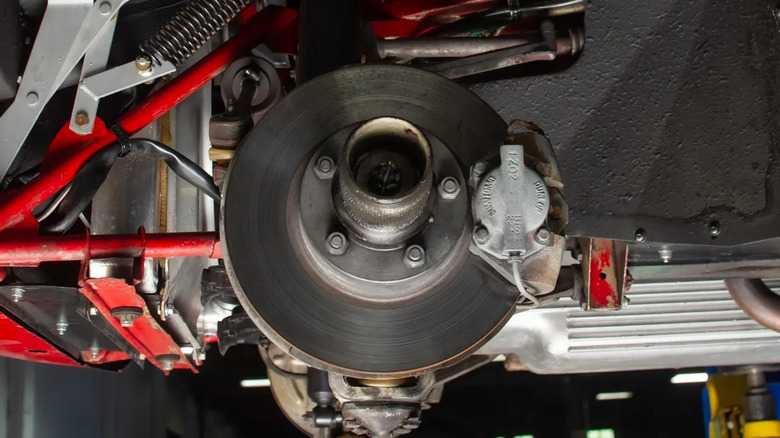 Close-up of a brake disc and Dunlop-branded caliper on a vintage Jaguar