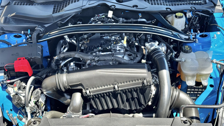 A photo under the hood of the blue Mustang Ecoboost showing its 2.3-Liter EcoBoost four-cylinder