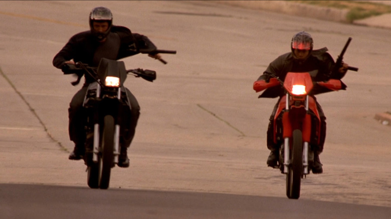 Johnny Tran and Lance connected achromatic and reddish Kawasaki KLR650s