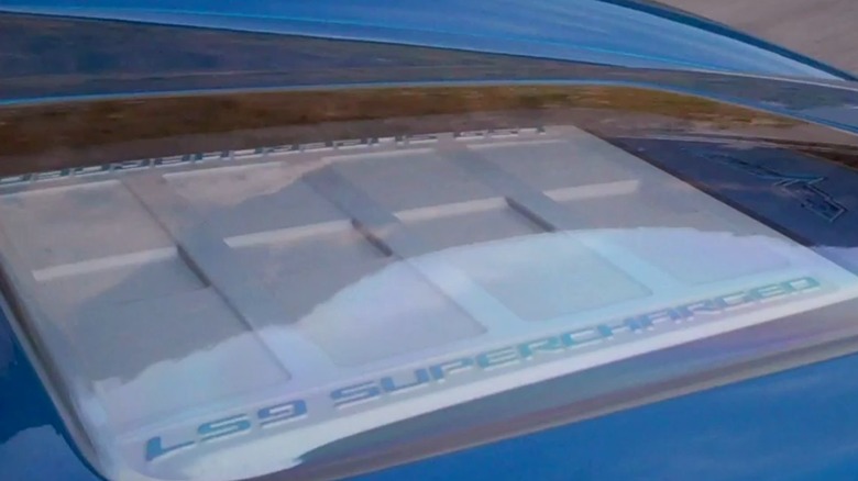 A view of the glass viewing window on the hood of a C6 Chevrolet Corvette ZR1, giving a view of the supercharged 6.2-liter LS9 V8