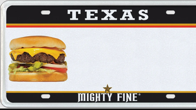 A license plate promoting the Texas Mighty Fine burger chain