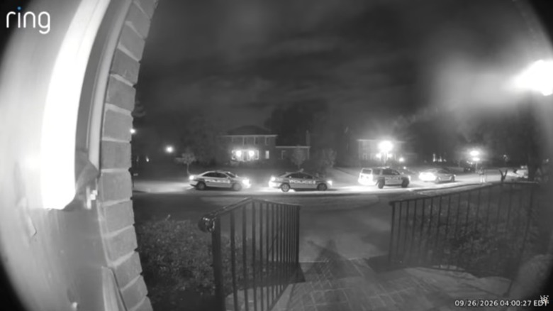 A Ring camera image of several police cars parked on the street outside a home