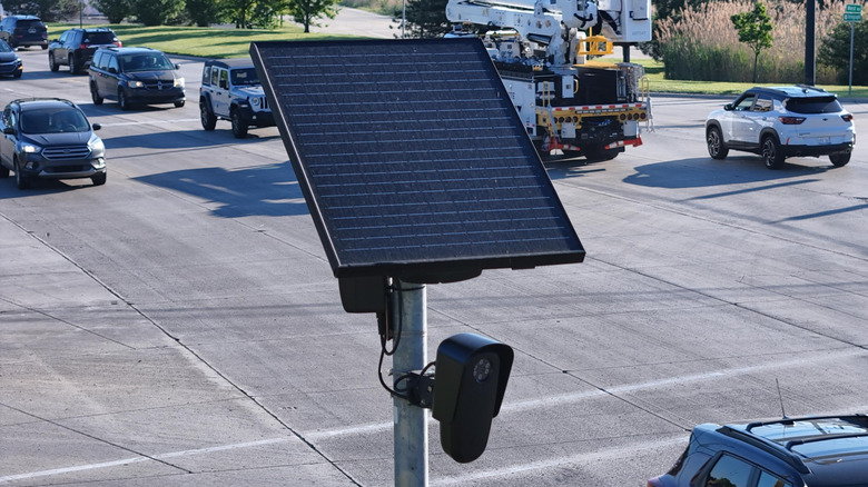 Brownstown, Michigan, USA - May 31, 2026: Flock Safety roadside traffic surveillance and data collection camera equipment featuring a solar panel and dual sensors, monitoring vehicles on a public roadway.