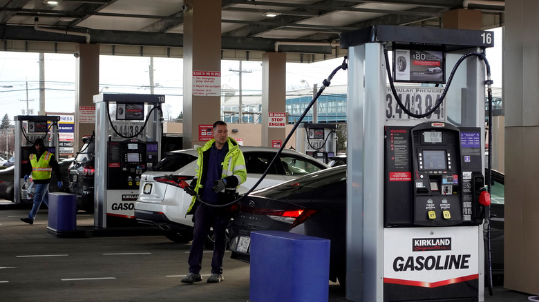 Attendant filling up a car at a Costco gas station