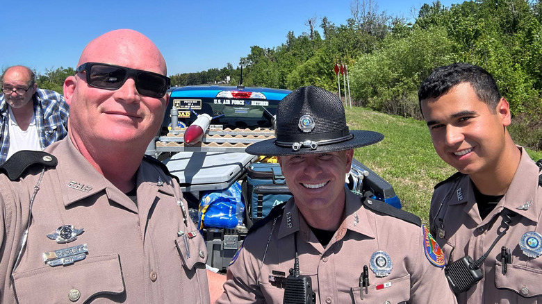 Florida Highway Patrol troopers pose for a selfie in front of Michael Nipper and his DIY missile truck