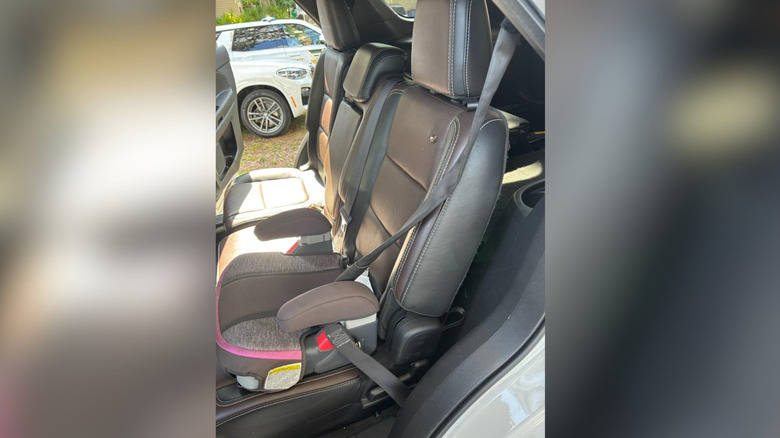 The victim's back seat with a bullet hole where a child was sitting in a booster seat