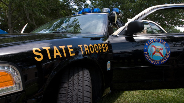 A Florida Highway Patrol car parked with the door open