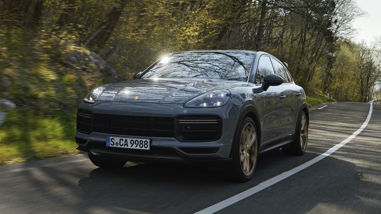 A gray 2021 Porsche Cayenne Turbo GT on a country road.