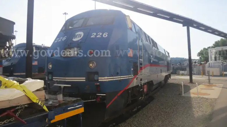 Blue, red, and silver MTA locomotive number 226
