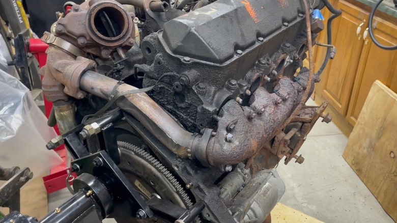 Image of the Ford 7.3 Power Stroke engine with the up pipe and exhaust manifold in view