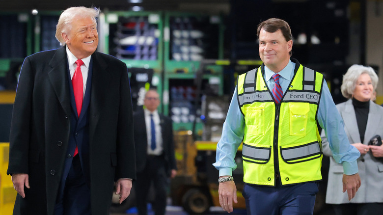 U.S. President Donald Trump (L) walks with CEO of Ford Motor Company Jim Farley as they tour the Ford River Rouge Complex on January 13, 2026 in Dearborn, Michigan.