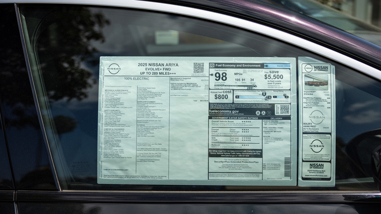 TORRANCE, CALIFORNIA - APRIL 3: The Monroney label, or window sticker, for a 2025 Nissan Ariya Evolve, with a final price of $47,115, at the Nissan of Torrance auto dealership, selling Honda cars, trucks and SUVs, on April 3, 2025 in Torrance, California. Car dealers are bracing for the effects of President Trump's newly imposed tariffs, saying the increases that will be attached to new foreign car imports and parts will likely be passed onto consumers, creating greater demand for used cars, that will not have tariff-pricing.