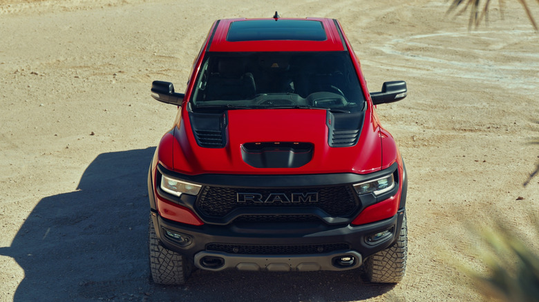 A red 2023 Ram 1500 TRX on an unpaved surface.