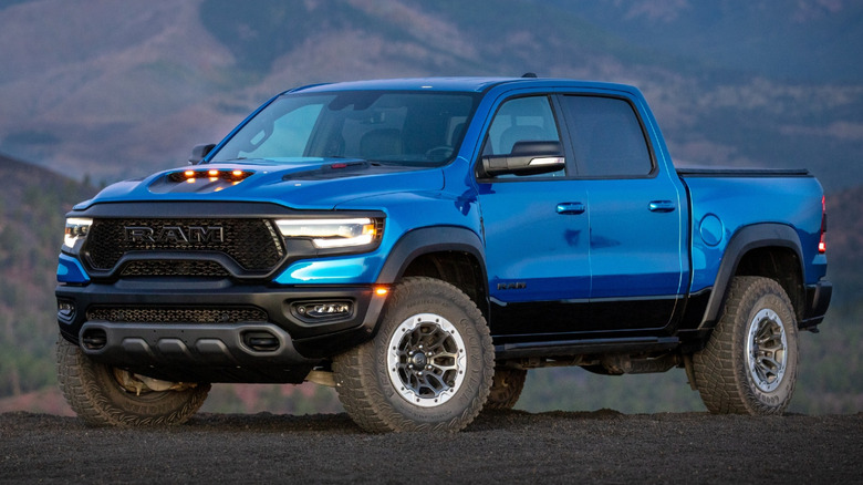 A blue 2020 Ram 1500 TRX in front of hills.