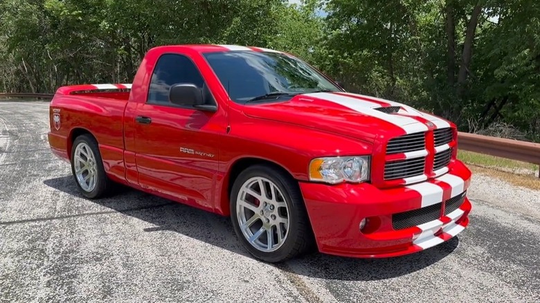 A red 2004 Ram SRT-10 with white stripes parked outside