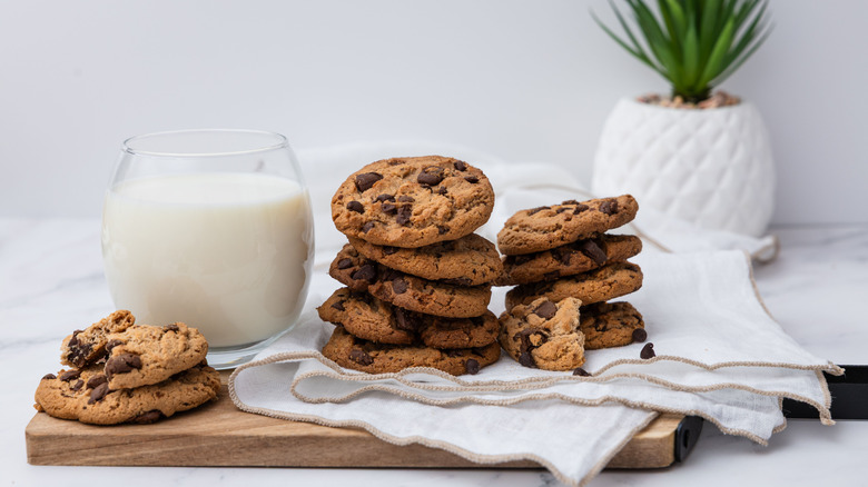 Stock image of some chocolate chip cookies and a glass of milk.