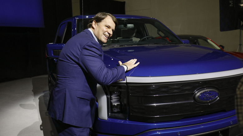 Ford CEO Jim Farley pats a Ford F-150 Lightning in 2023