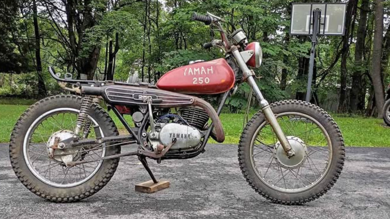 A red Yamaha DT250 in a state of disrepair