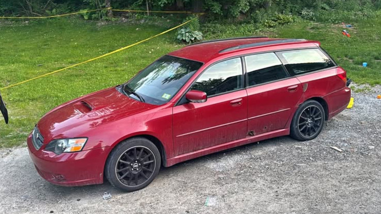 A red Subaru Legacy GT wagon
