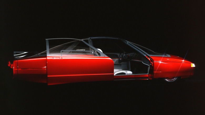 A right side view of a 1987 Ford Probe V concept car amidst a dark background