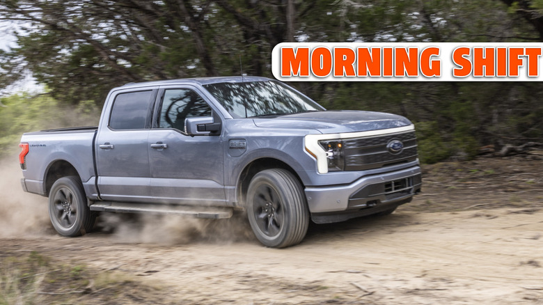 A gray F150 Lightning drives offroad