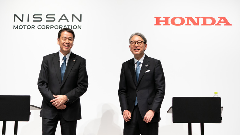 TOKYO, JAPAN - MARCH 15: Nissan Motor CEO Makoto Uchida (L) and Honda Motor CEO Toshihiro Mibe (R) attend a joint press conference on March 15, 2024 in Tokyo, Japan. The automakers announced their partnership on electric vehicles today to compete with rival EV manufacturers such as China's BYD or US-based Tesla.