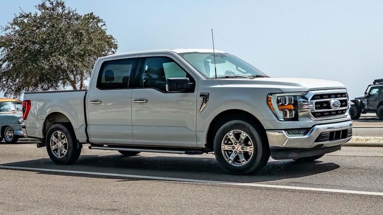 A wide angle front corner view of a 2021 Ford F150 Super Cab XLT Pickup at a local car show.