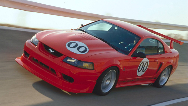 A red 2000 Ford SVT Mustang Cobra R on a test track.