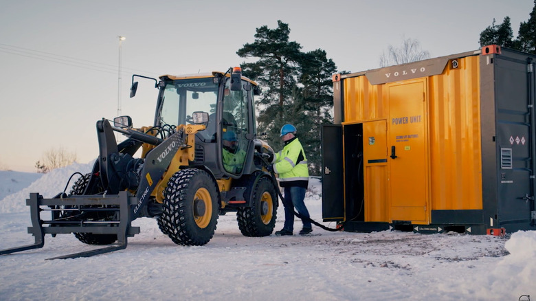 An electric Volvo construction vehicle being charged by a PU500 power unit.