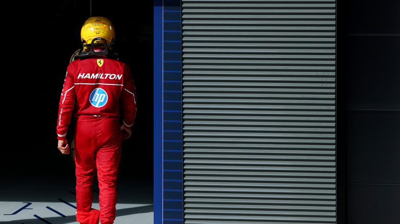Lewis Hamilton of Ferrari walks back into the pits.