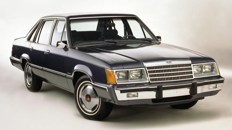 A black 1983 Ford Fairmont four-door sedan.