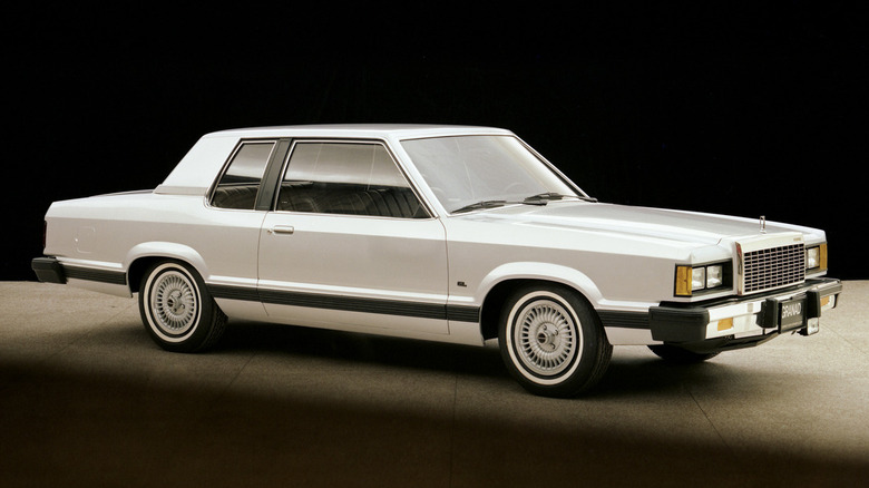 A silver 1981 Ford Granada Coupe pictured against a black backdrop.