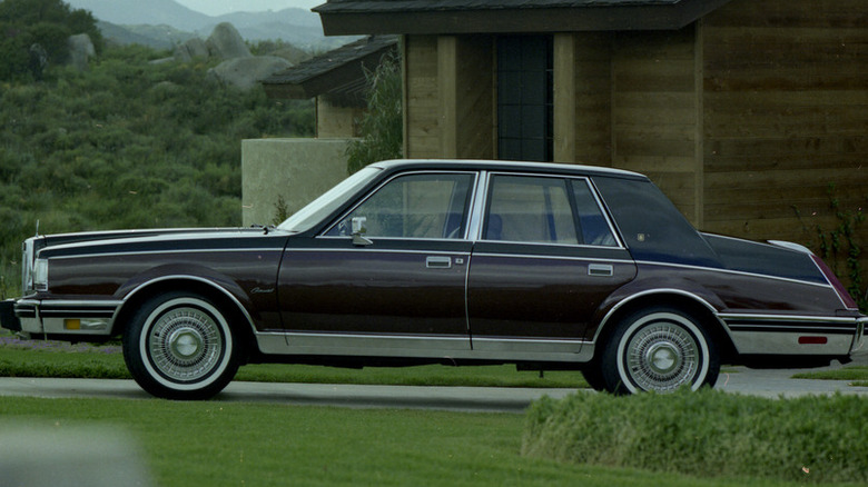 A brown and black 1982 Lincoln Continental parked in a home driveway.
