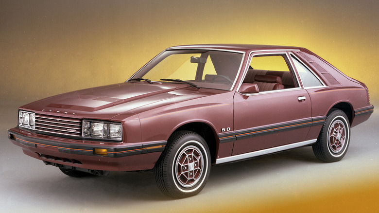 Brick colored 1979 Mercury Capri pictured in photo studio.