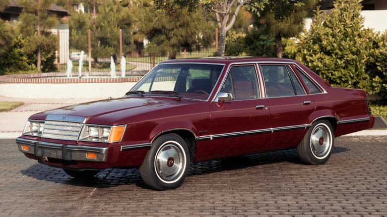 Three quarter view image of a red 1984 Mercury Marquis.