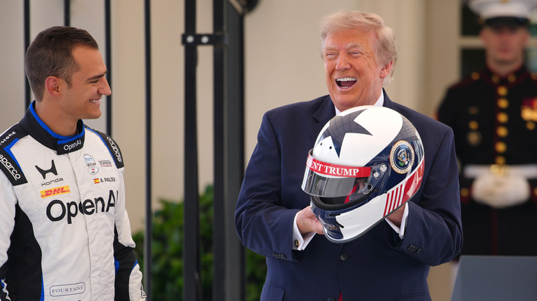 WASHINGTON, DC - JULY 13: U.S. President Donald Trump receives a racing helmet from reigning IndyCar series champion Alex Palou at a Freedom 250 Grand Prix showcase on West Executive Avenue between the West Wing of the White House and the Eisenhower Executive Office Building on July 13, 2026 in Washington, DC. The IndyCar Freedom 250 Grand Prix car race, August 22 and 23 on the National Mall, is part of America's 250th anniversary celebrations. (Photo by Andrew Harnik/Getty Images)