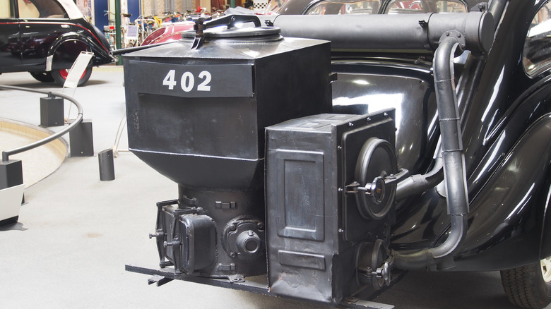 A 1940 Peugeot 402B Limousine à Gazogène with its coal-burning apparatus on the back, photographed at the Musée de l'Aventure Peugeot-Sochaux, France.
