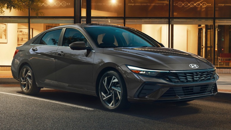 A dark grey Hyundai Elantra Hybrid sedan sits in a parking spot.