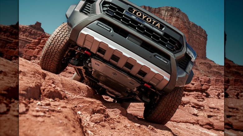 The Toyota Tacoma tackling an off-road trail.